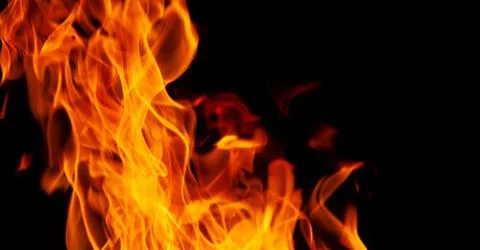 Orange fire flames on a black background 스톡 사진