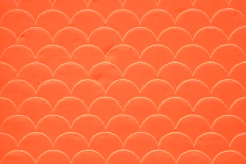 Orange fish scale seamless pattern on decorated cement wall Stock Photos