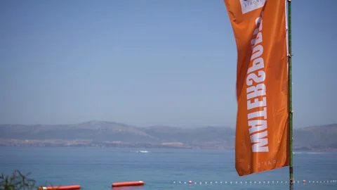Orange Flag waving in the wind - Slow Motion Video stock 111804246