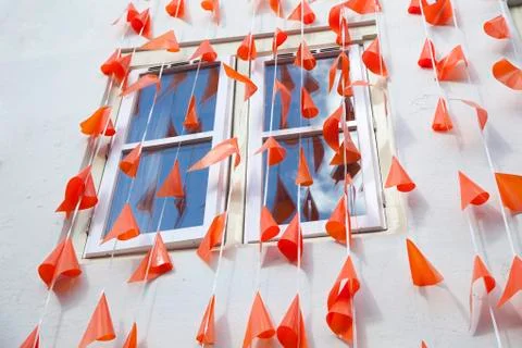 Orange flags against white wall Stock Photos
