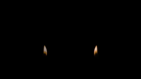 An Orange Flame and Its Reflections Flickers Against a Black Background Stock Footage 270304556