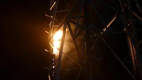 Orange flame burning at night on cellphone tower after being set off Stock Footage 130043001