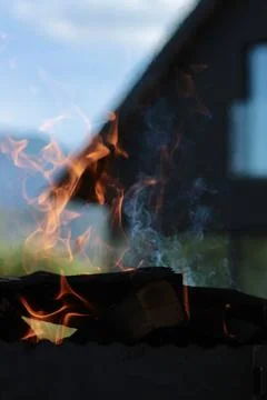 Orange flame of fire on the background of the house. Stock Photos