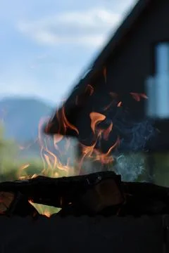 Orange flame of fire on the background of the house. Stock Photos