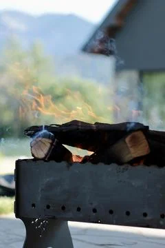 Orange flame of fire on the background of the house. Stock Photos