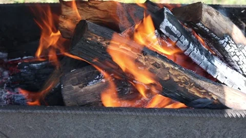 Orange flame over the burning wood. Embers of black firewood burn-out. Stock Footage 233156040
