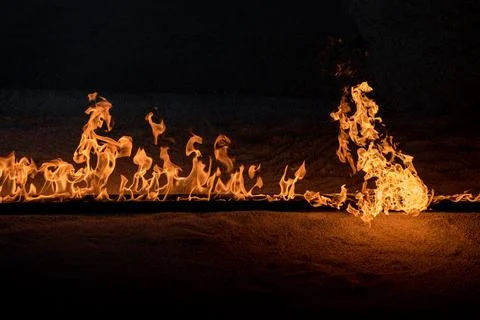 Orange Flames on black background Stock Photos