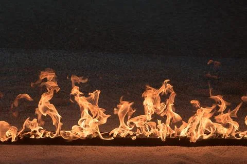 Orange Flames on black background Stock Photos