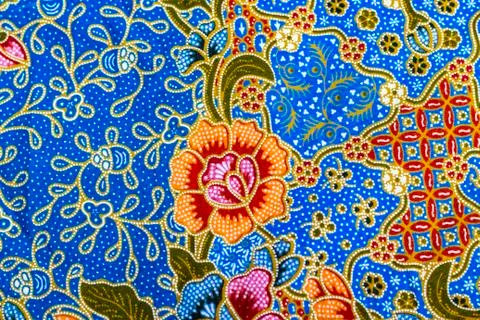 Orange flower pattern on batik Stock Photos