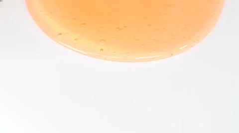 Orange fluid gel on white background Stock Footage 35569732