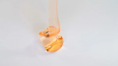 Orange fluid gel on white background Stock Footage 35570055