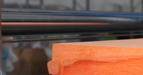 Orange foam cube moves back and forth through knife. Modern production, plant Stock Footage 128637227