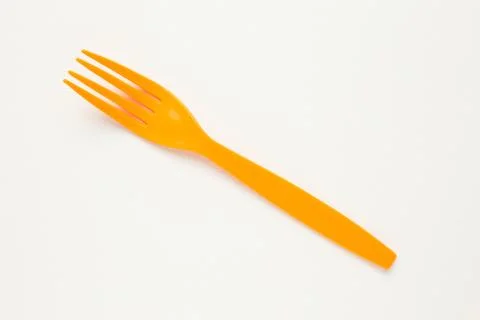 Orange fork on white canvas background. Stock Photos