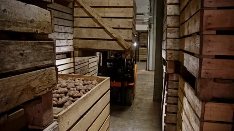 Orange forklift with unrecognizable driver stack wooden boxes on top of each Stock-Footage 228127982