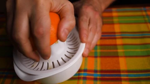 Orange fresh. Recipe. A hand presses an orange to a juicer. Rotation 库存影片 123790609