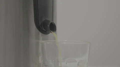 Orange freshly squeezed juice flows from the juicer tap. Slow motion. slog 3. 스톡 동영상 305151840