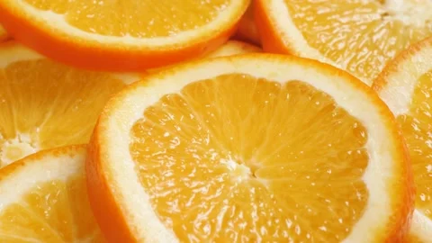 Orange fruit. Camera slowly pans down to show macro shot of fresh juicy sliced Stockbeeldmateriaal 169554773