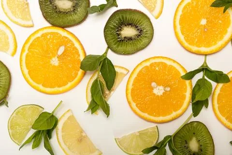 Orange fruit, lemon, lime, mint, kiwi top view. Stock Photos