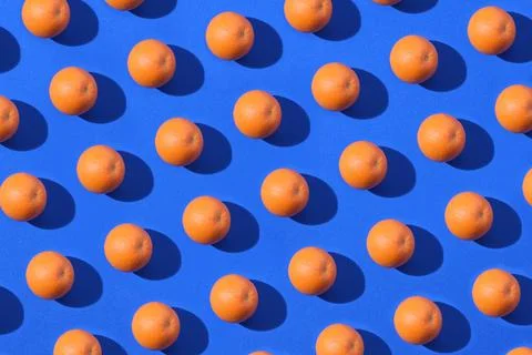 Orange fruit pattern on a blue background Stock Photos