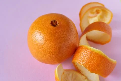 Orange fruit on a pink background, close-up, selective focus Stock Photos