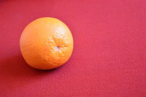 Orange fruit on a red background Stock-Fotos