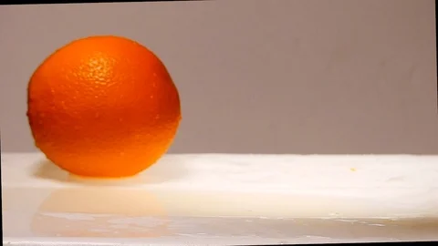 Orange fruit slice falling down slow motion Stock Footage 87804921