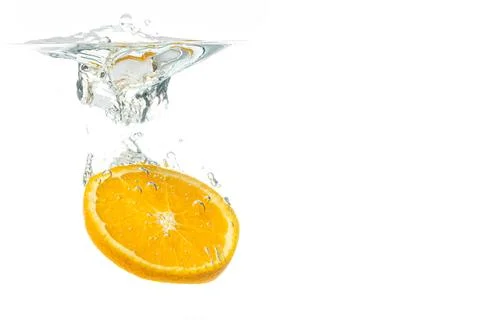 Orange fruit slice in water splash Stock Photos