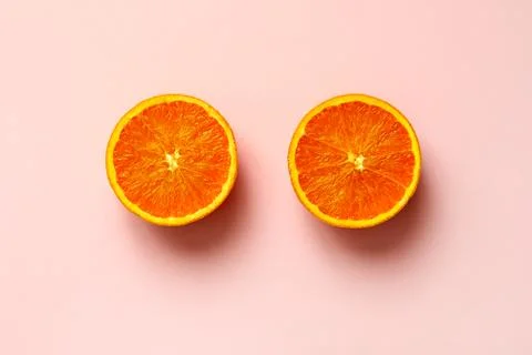 Orange fruit sliced in half isolate on pink background Stock Photos