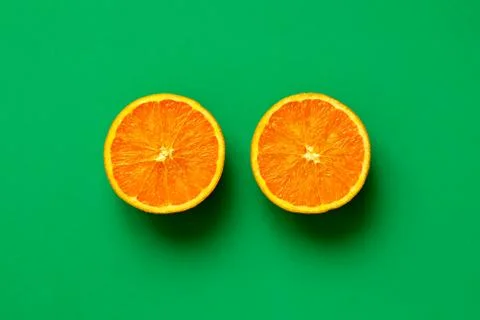 Orange fruit sliced in half isolate on green background Stock Photos