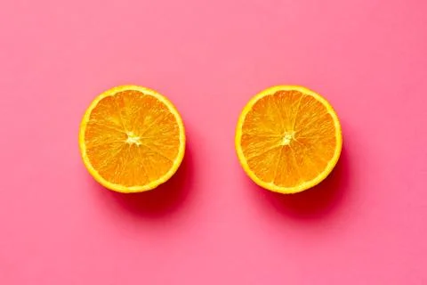 Orange fruit sliced in half isolate on fuscia background Stock Photos