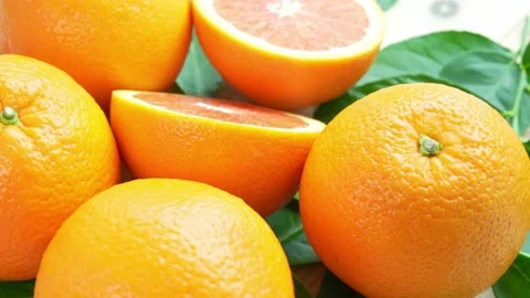 Orange fruit with slices closeup, Top view Rotate fruits. Stock Footage 235388652