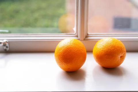 Orange fruit on soft light window background 写真素材
