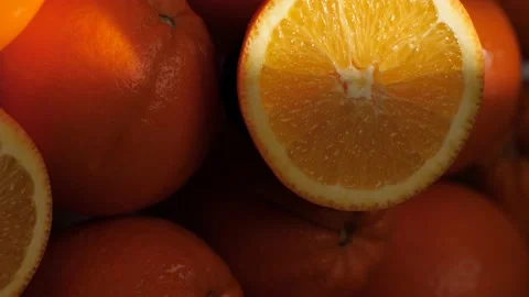 Orange fruit. Vertical view of beam of light illuminates cut orange fruit in Видео 168467668