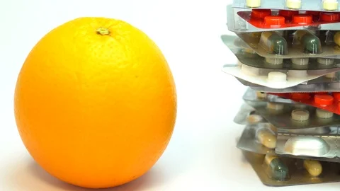 Orange fruit with vitamin c tablet on white background Stockbeeldmateriaal 88333231