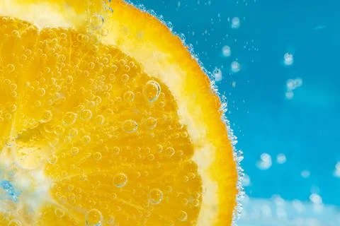 Orange fruit in the water close-up macro. Refreshing grapefruit drink, cockta 写真素材