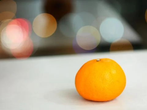 Orange fruit on white table on bokeh background Stock Photos