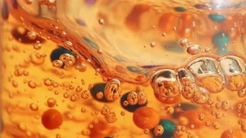 Orange gel, serum with bubbles slowly flows down in a transparent bottle, macro Stock Footage 233567078