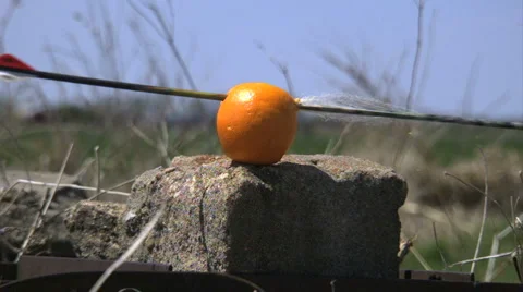 Orange getting sliced by arrow in super slow motion / high speed Stock Footage