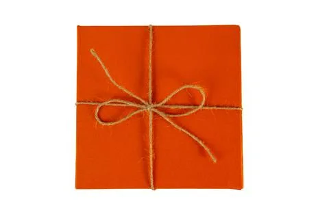 Orange gift box with twine bow isolated on white background Stock Photos