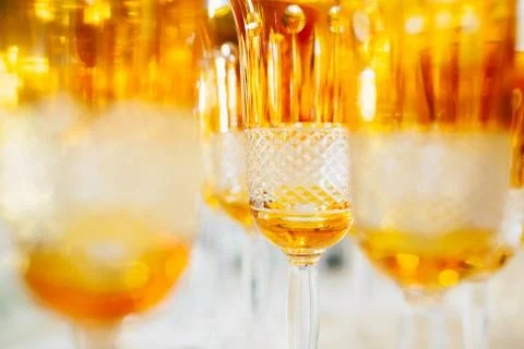 Orange glasses in a row - texture with light behind Stock Photos