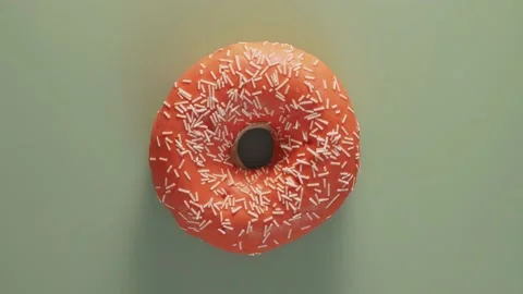 Orange glazed donut rotating on blue, top view Stock Footage 153886740
