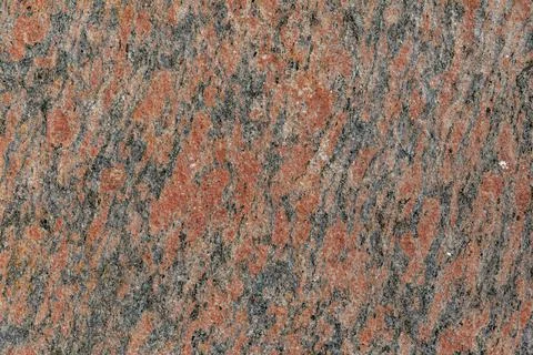 Orange granite close-up. background from the texture of stone. Stock Photos