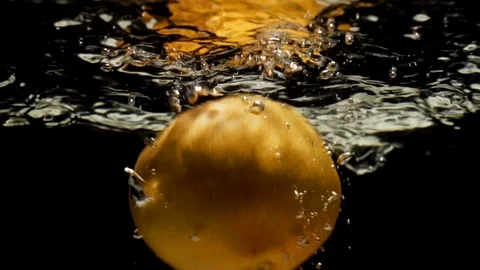 Orange grapefruir falling into water Stock Footage 90386351
