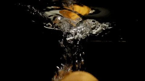 Orange grapefruit falling down into water with splashes. Stock Footage 90386330