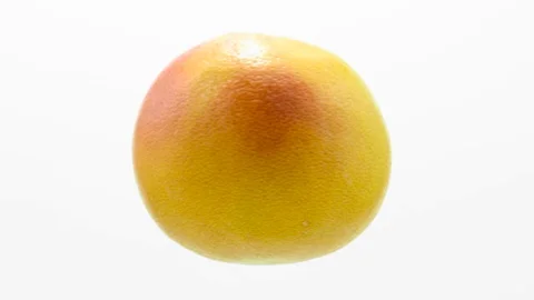 Orange grapefruit  suspended in the air rotates in loop    Stock Footage 69948356