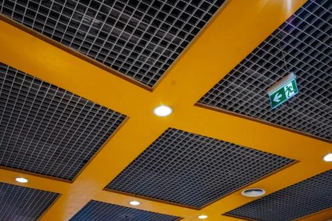Orange grid structure of suspended ceiling in an mall building. Abstract mode Stock Photos