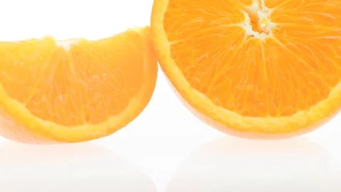 An orange half and two slices - extreme closeup pan with extreme detail Stock Footage 104838575