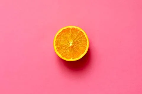 Orange half fruit sliced isolate on fuscia background Stock Photos