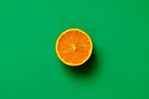 Orange half fruit sliced isolate on green background Stock Photos