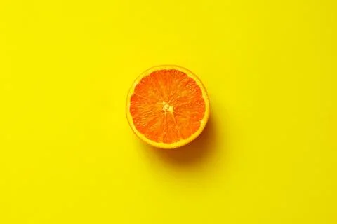 Orange half fruit sliced isolate on yellow background Stock Photos
